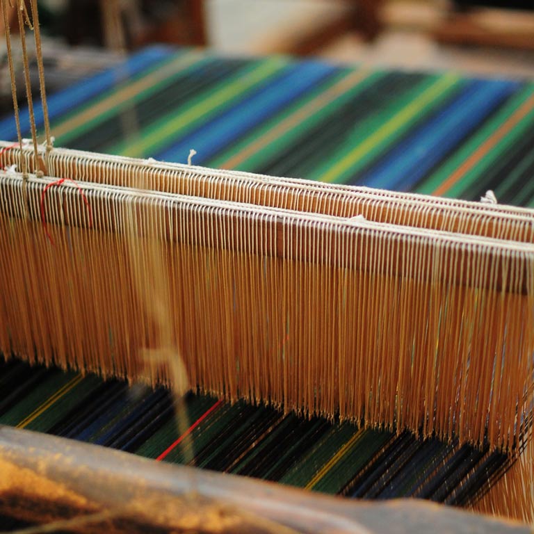 Close up of a loom creating a colorful textile
