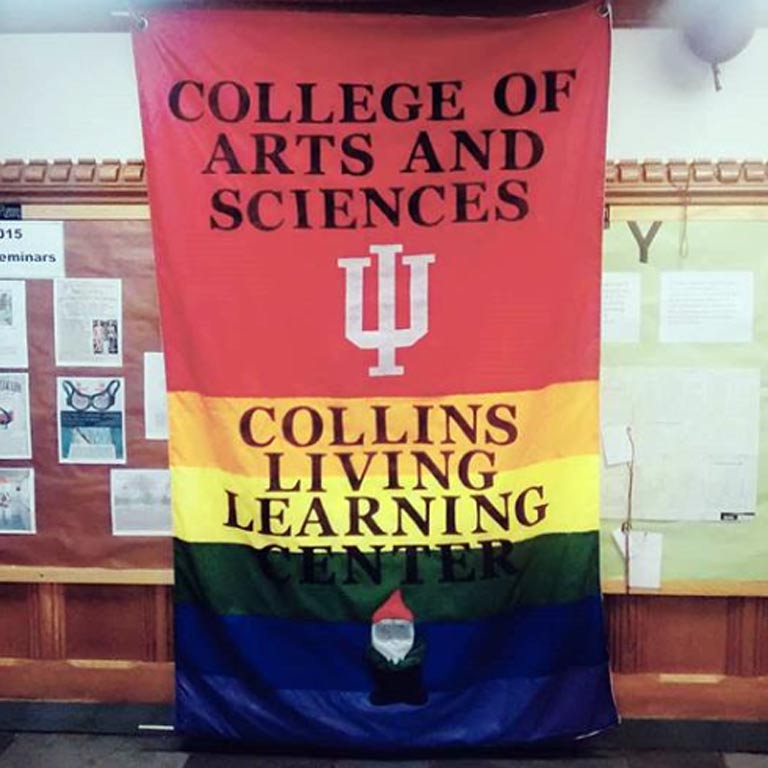 Rainbow banner with the image of a gnome at the bottom that says, "College of Arts and Sciences, Collins Living-Learning Center"